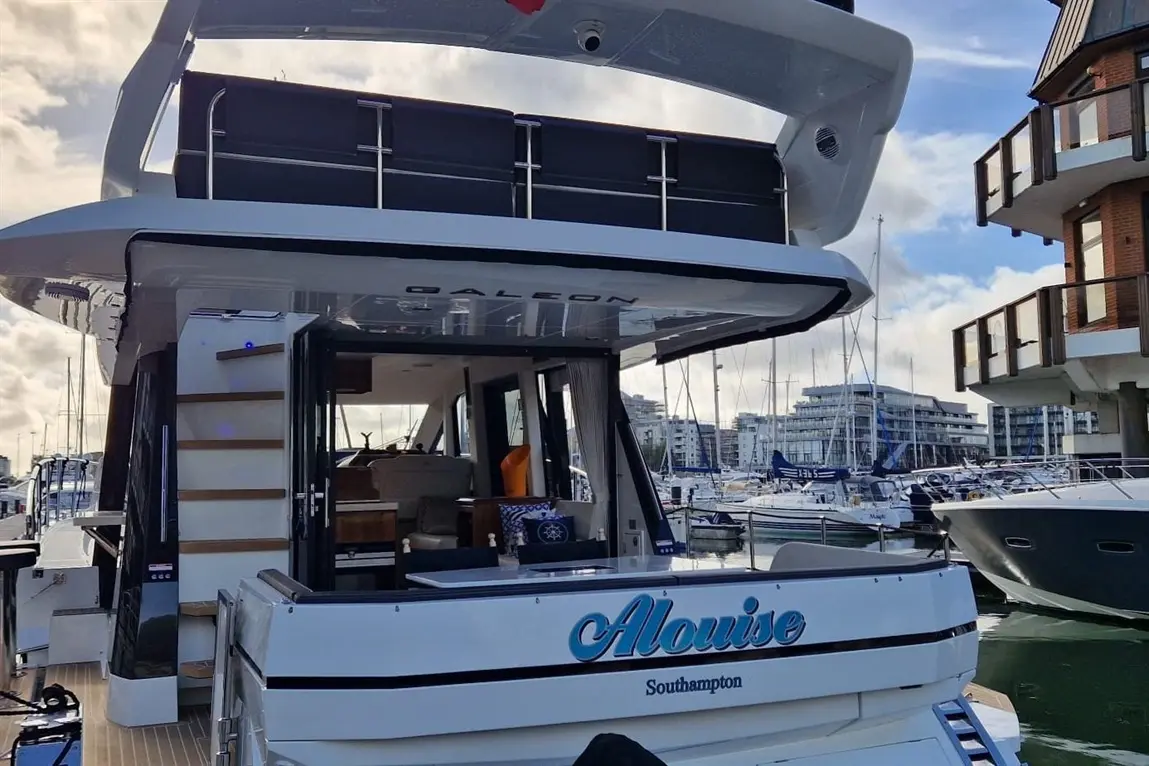 A luxury yacht named "Alouise" docked in Southampton with a modern design and visible marina in the background.